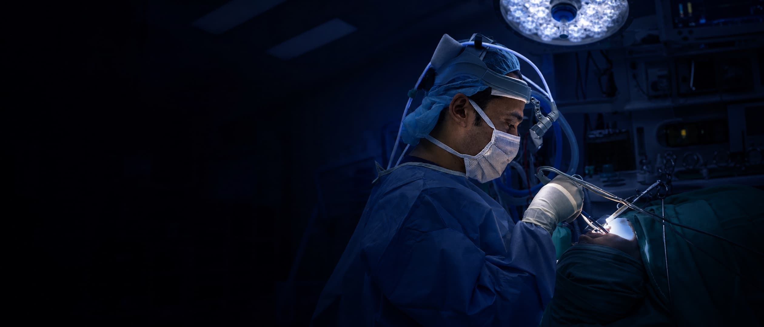 A/Prof Faruque Riffat operating under theatre lights.