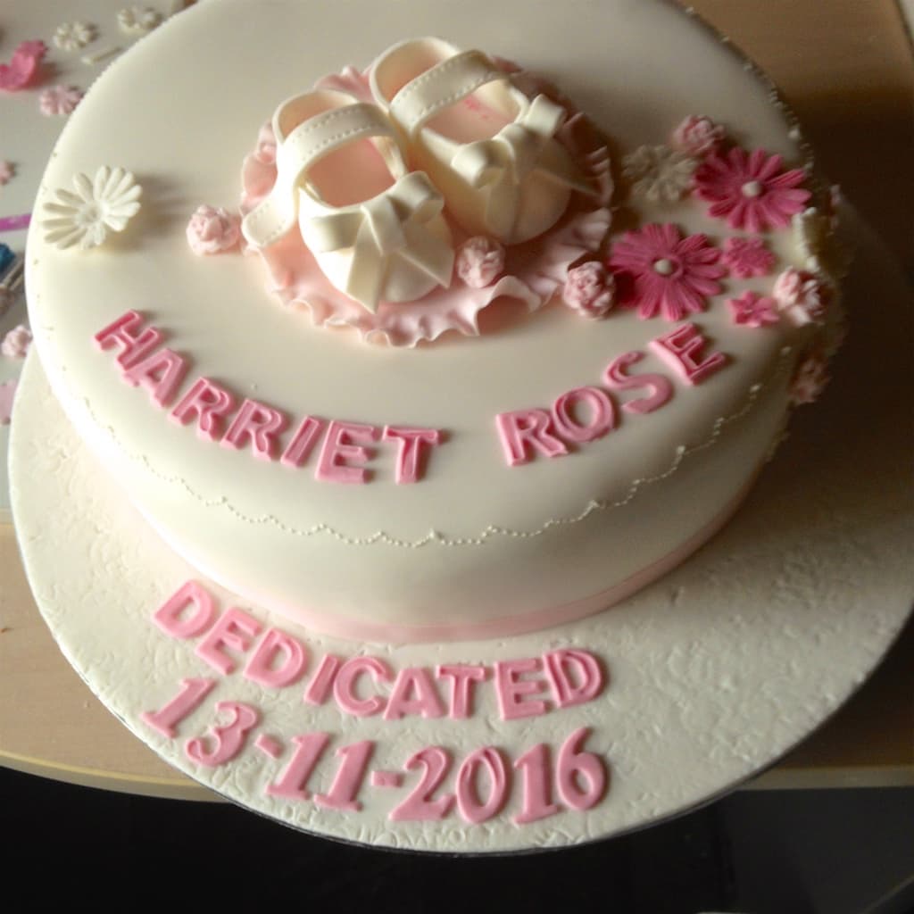 Pink-and-white christening cake with sugar ballet slippers reading 'Harriet Rose · Dedicated 13-11-2016'