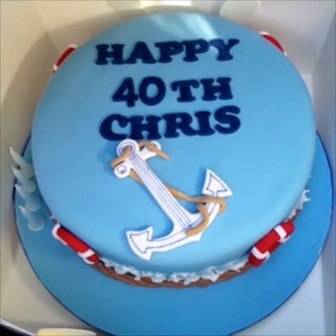 Nautical 40th birthday cake with anchor, lifebuoys and rope detailing, reading 'Happy 40th Chris'